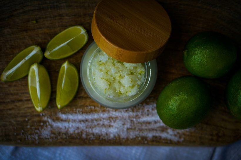 limes, sugar, and lime slices on a cutting board